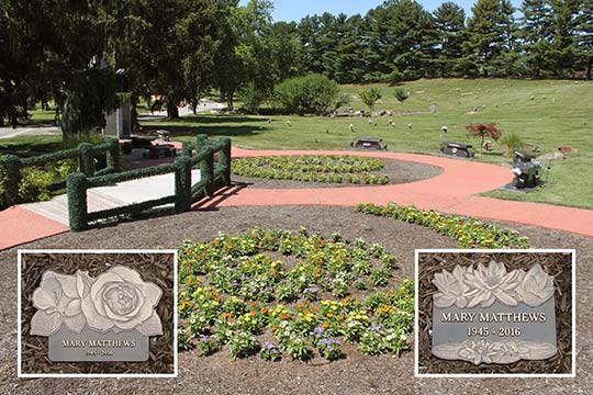 Bronze cremation memorials with flower designs in the Tranquility Garden.